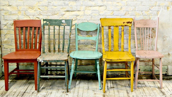 five chairs using different colors of milk paint